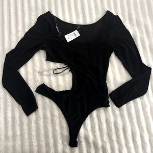 Black body suit. Rhinestone cut out side